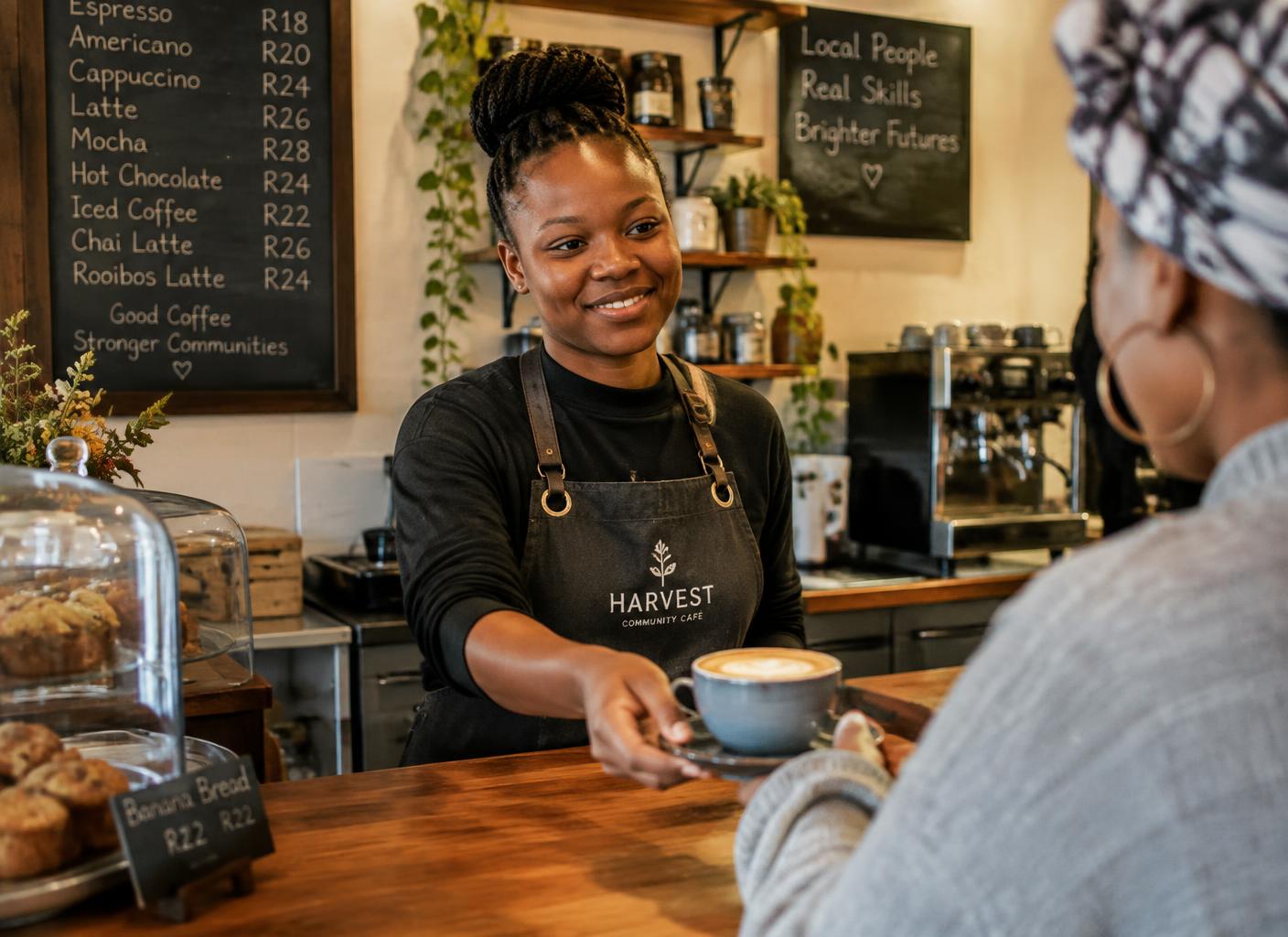 AI-generated illustration of a young barista serving coffee at a community café